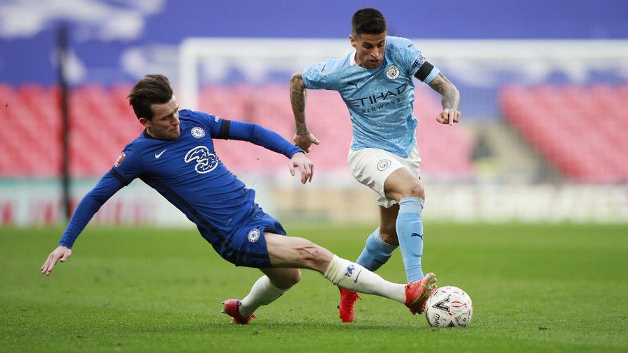 Chelsea's Ben Chilwell, left, tackles Manchester City's Joao Cancelo during the English FA Cup semifinal soccer match between Chelsea and Manchester City at Wembley Stadium in London, England, Saturday, April 17, 2021. (AP Photo/Ian Walton, Pool)