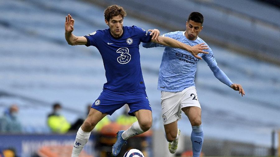 Chelsea's Marcos Alonso, left, and Manchester City's Joao Cancelo challenge for the ball during the English Premier League soccer match between Manchester City and Chelsea at the Etihad Stadium in Manchester, Saturday, May 8, 2021.(Shaun Botterill /Pool via AP)