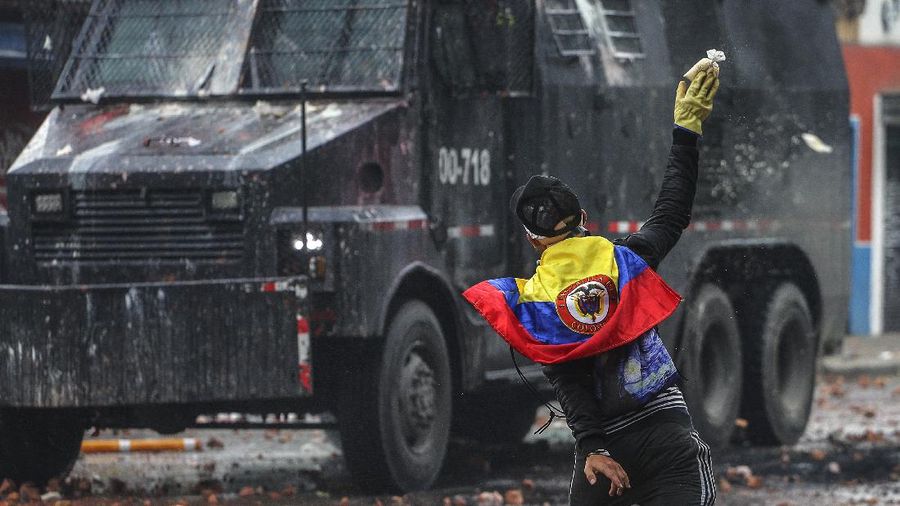 Protesters who call themselves the front line hold homemade shields during an anti-government protest in Bogota, Colombia, Friday, May 28, 2021. Colombians have taken to the streets for weeks across the country after the government proposed tax increases on public services, fuel, wages and pensions. (AP Photo/Fernando Vergara)