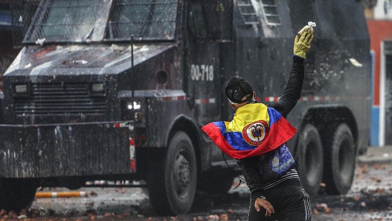 Protesters who call themselves the front line hold homemade shields during an anti-government protest in Bogota, Colombia, Friday, May 28, 2021. Colombians have taken to the streets for weeks across the country after the government proposed tax increases on public services, fuel, wages and pensions. (AP Photo/Fernando Vergara)