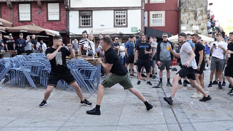 Police moves in to stop a scuffle that started among Manchester City supporters drinking by the Douro river bank in Porto, Portugal, Friday, May 28, 2021. English clubs Manchester City and Chelsea will play the Champions League soccer final in Porto on Saturday. (AP Photo/Luis Vieira)