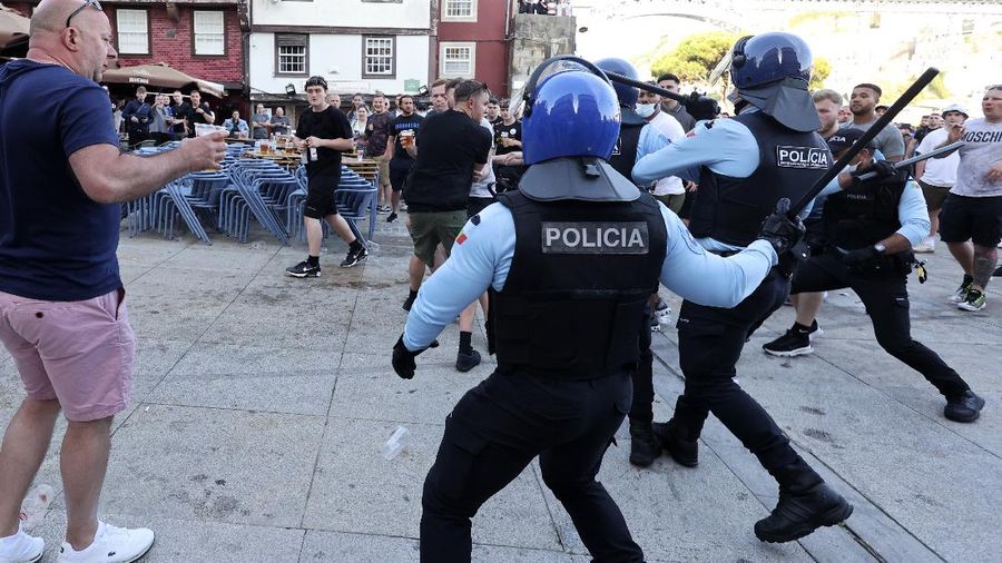 Police moves in to stop a scuffle that started among Manchester City supporters drinking by the Douro river bank in Porto, Portugal, Friday, May 28, 2021. English clubs Manchester City and Chelsea will play the Champions League soccer final in Porto on Saturday. (AP Photo/Luis Vieira)