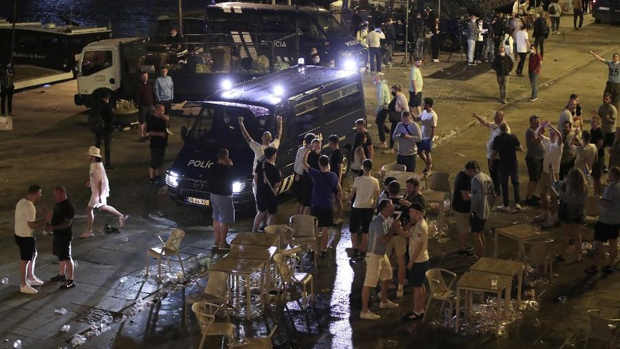 Police moves in to stop a scuffle that started among Manchester City supporters drinking by the Douro river bank in Porto, Portugal, Friday, May 28, 2021. English clubs Manchester City and Chelsea will play the Champions League soccer final in Porto on Saturday. (AP Photo/Luis Vieira)
