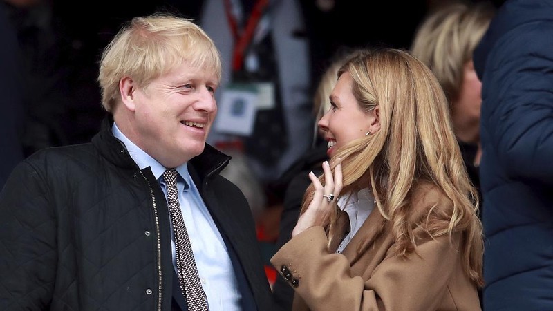 Britain's Prime Minister Boris Johnson and his partner Carrie Symonds, stand outside 10 Downing Street to join in the nationwide Clap for Carers to recognise and support National Health Service (NHS) workers and carers fighting the coronavirus pandemic, in London Thursday May 14, 2020. The highly contagious COVID-19 coronavirus has impacted on nations around the globe, many imposing self isolation and exercising social distancing when people move from their homes. (Victoria Jones / PA via AP)