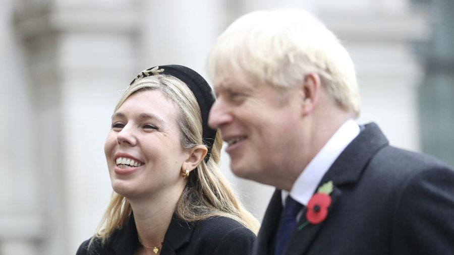 Britain's Prime Minister Boris Johnson and his partner Carrie Symonds, stand outside 10 Downing Street to join in the nationwide Clap for Carers to recognise and support National Health Service (NHS) workers and carers fighting the coronavirus pandemic, in London Thursday May 14, 2020. The highly contagious COVID-19 coronavirus has impacted on nations around the globe, many imposing self isolation and exercising social distancing when people move from their homes. (Victoria Jones / PA via AP)