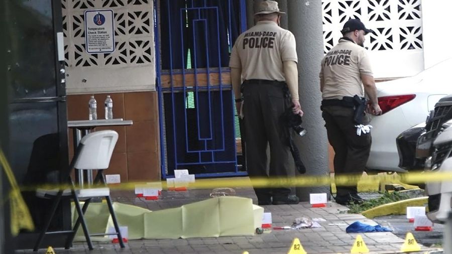 Miami-Dade Police work the scene of a shooting outside a banquet hall near Hialeah, Fla., Sunday, May 30, 2021. Two people died and an estimated 20 to 25 people were injured in a shooting outside a banquet hall in South Florida, police said. The gunfire erupted early Sunday at the El Mula Banquet Hall in northwest Miami-Dade County, near Hialeah, police told news outlets. (Joe Cavaretta/South Florida Sun-Sentinel via AP)