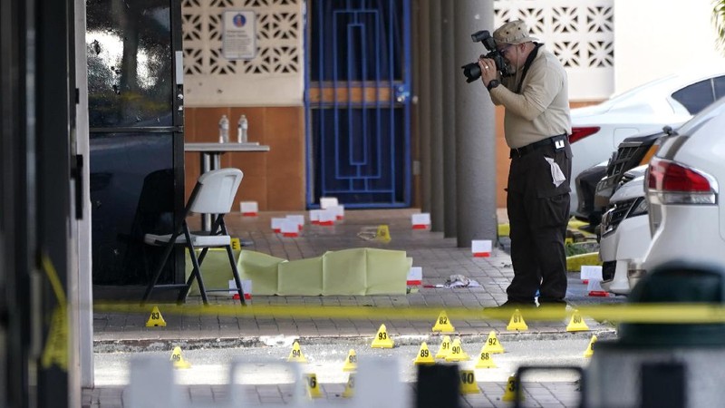 Miami-Dade Police work the scene of a shooting outside a banquet hall near Hialeah, Fla., Sunday, May 30, 2021. Two people died and an estimated 20 to 25 people were injured in a shooting outside a banquet hall in South Florida, police said. The gunfire erupted early Sunday at the El Mula Banquet Hall in northwest Miami-Dade County, near Hialeah, police told news outlets. (Joe Cavaretta/South Florida Sun-Sentinel via AP)