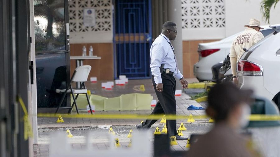 Miami-Dade Police work the scene of a shooting outside a banquet hall near Hialeah, Fla., Sunday, May 30, 2021. Two people died and an estimated 20 to 25 people were injured in a shooting outside a banquet hall in South Florida, police said. The gunfire erupted early Sunday at the El Mula Banquet Hall in northwest Miami-Dade County, near Hialeah, police told news outlets. (Joe Cavaretta/South Florida Sun-Sentinel via AP)