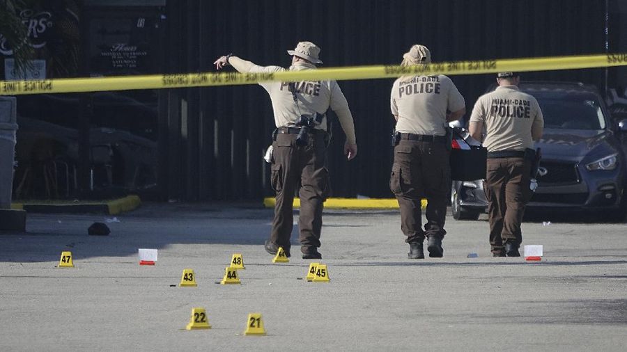 Miami-Dade Police work the scene of a shooting outside a banquet hall near Hialeah, Fla., Sunday, May 30, 2021. Two people died and an estimated 20 to 25 people were injured in a shooting outside a banquet hall in South Florida, police said. The gunfire erupted early Sunday at the El Mula Banquet Hall in northwest Miami-Dade County, near Hialeah, police told news outlets. (Joe Cavaretta/South Florida Sun-Sentinel via AP)