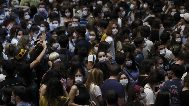 Thousands of people, masked and tested for the virus, pack inside a Paris concert hall as part of a public health experiment to prepare the country to host big events again, in Paris, Saturday, May 29, 2021. The concert in the AccorHotels Arena in eastern Paris features 1980s French rock band Indochine and DJ Etienne de Crecy. (AP Photo/Francois Mori)