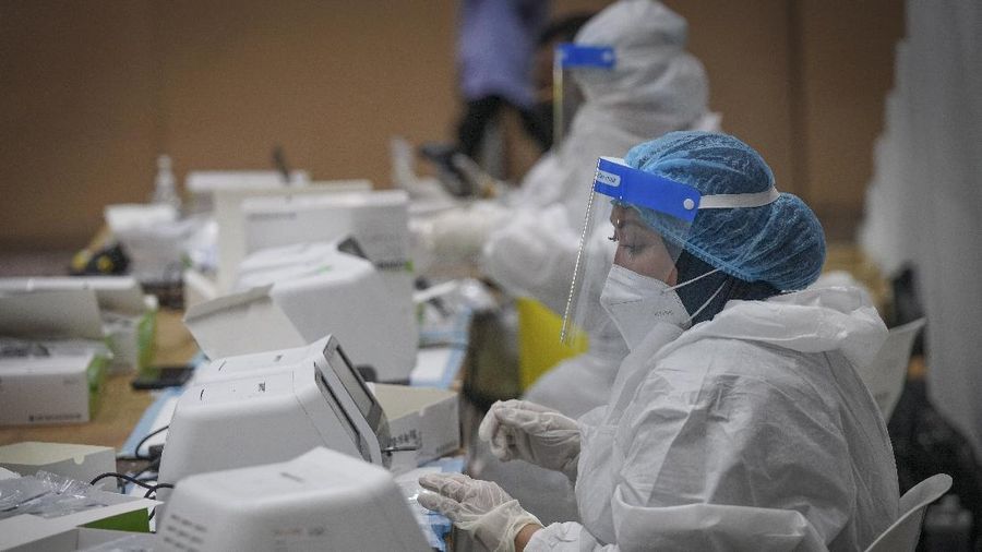 Medical workers examine samples from coronavirus testing at a COVID-19 testing center in Ulu Klang, on the outskirts of Kuala Lumpur, Malaysia, Tuesday, May 18, 2021. (AP Photo/Vincent Thian)