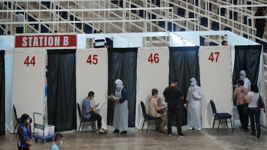 A man receives the Pfizer's vaccine for the coronavirus at a vaccination center in Kuala Lumpur, Malaysia, Monday, May 31, 2021. An exhibition center in Malaysia has been turned into the country's first mega vaccination center as the government aims to speed up inoculations amid a sharp spike in infections. (AP Photo/Vincent Thian)