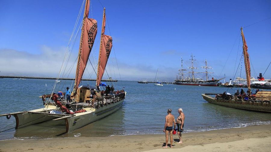 Two swimmers look over a Pacific Voyagers vaka from Fiji tied up on the beach at Aquatic Park in San Francisco, Tuesday, Aug. 9, 2011. In April, seven traditional Polynesian ocean-going vessels called vakas and their 16 member crews, set sail on a 15,000 nautical mile journey across the Pacific. The group arrived in San Francisco last week and is traveling down the West Coast to raise awareness for the health of our oceans. The vakas tied up on the beach at the park to allow the public to tour the boats. (AP Photo/Eric Risberg)