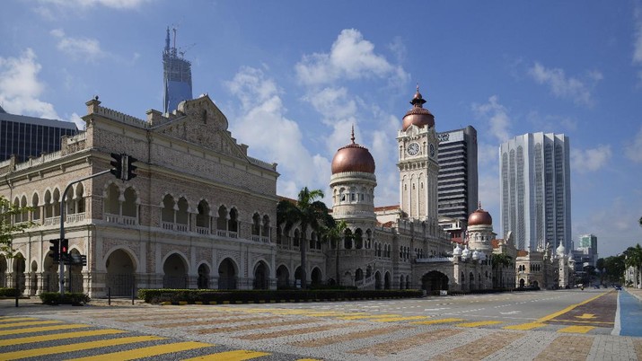The roadway in front of the Dataran Merdeka, known as Independence Square, is empty during the first day of Full Movement Control Order (MCO) in Kuala Lumpur, Malaysia, Tuesday, June 1, 2021. Malls and most businesses in Malaysia shuttered Tuesday as the country began its second near total coronavirus lockdown to tackle a worsening pandemic that has put its healthcare system on the verge of collapse. (AP Photo/Vincent Thian)