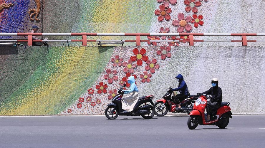 People ride motorcycles in Hanoi, Vietnam Monday, May 31, 2021. Vietnam plans to test all 9 million people in its largest city for the coronavirus and imposed more restrictions Monday to deal with a growing COVID-19 outbreak. (AP Photo/Hau Dinh)