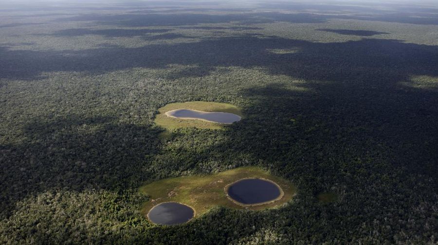 An aerial view of some freshwater filled sinkholes, known in Spanish as 'cenotes', in the Yucatan peninsula, Mexico, Tuesday, Nov. 30, 2010. During the annual UN Climate Change Conference which is being held in Cancun, Mexico, the World Meteorological Organization said Tuesday the heat waves that killed thousands of people in Europe in 2003 and that choked Russia earlier this year, will appear like an average summer in the future as the Earth continues to warm. (AP Photo/Eduardo Verdugo)