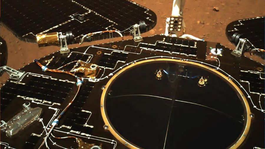 In this photo taken by China's Zhurong Mars rover and made available by the China National Space Administration (CNSA) on Wednesday, May 19, 2021, the rover's solar panels and antenna are deployed as the rover sits on its lander on the surface of Mars. China landed a spacecraft on Mars for the first time on Saturday, a technically challenging feat more difficult than a moon landing, in the latest step forward for its ambitious goals in space. (CNSA via AP)