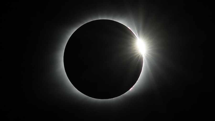 The diamond ring effect appears as the solar eclipse totality ends Monday, Aug. 21, 2017, over the Orchard Dale historical farm near Hopkinsville, Ky. The location, which is in the path of totality, is also at the point of greatest intensity. (AP Photo/Mark Humphrey)