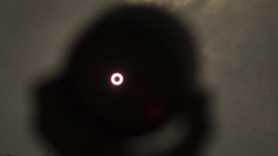 An annular solar eclipse is seen through a telescope in Siak, Riau province, Indonesia, Thursday, Thursday, Dec. 26, 2019. People along a swath of southern Asia gazed at the sky in marvel on Thursday at a
