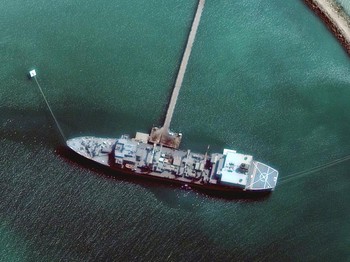 This photo provided by Maxar Technologies shows Iranian navy vessel Kharg in the Gulf of Oman off the coast of Jask, Iran, in this Thursday, June 3, 2021, satellite photo.  Satellite photographs show the burned hulk that remains of Iran’s biggest w