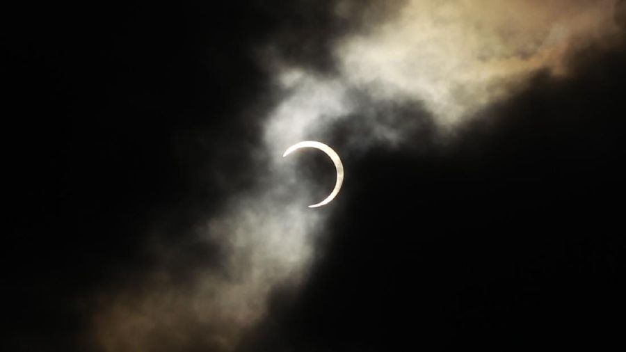 An annular solar eclipse appears during a break in clouds over Taipei, Taiwan, Monday, May 21, 2012. The annular eclipse, in which the moon passes in front of the sun leaving only a golden ring around its edges, was visible to wide areas across China, Japan and elsewhere in the region before moving across the Pacific to be seen in parts of the western United States. (AP Photo/Wally Santana)