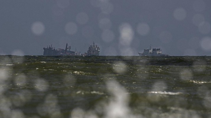 Sri Lanka Ship Fire The MV X-Press Pearl, left, is seen pulled by other navel vessels at Kapungoda, where it is anchored off Colombo port on the outskirts of Colombo, Sri Lanka, Wednesday, June 2, 2021. Salvage experts were attempting to tow the fire-stricken container ship that had been loaded with chemicals into the deep sea as the vessel started to sink Wednesday off Sri Lanka's main port, officials said. Water submerged the MV X-Press Pearl's quarterdeck a day after firefighters extinguished a blaze that had been burning for 12 days. (AP Photo/Eranga Jayawardena)
