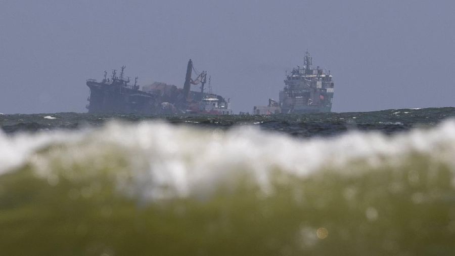 This photo provided by Sri Lankan Air Force shows the sinking MV X-Press Pearl at Kapungoda where it is anchored off Colombo port, Sri Lanka, Wednesday, June 2, 2021. Salvage experts were attempting to tow the fire-stricken container ship that had been loaded with chemicals into the deep sea as the vessel started to sink Wednesday. Water submerged the MV X-Press Pearl's quarterdeck a day after firefighters extinguished a blaze that had been burning for 12 days. (Sri Lanka Air Force via AP)