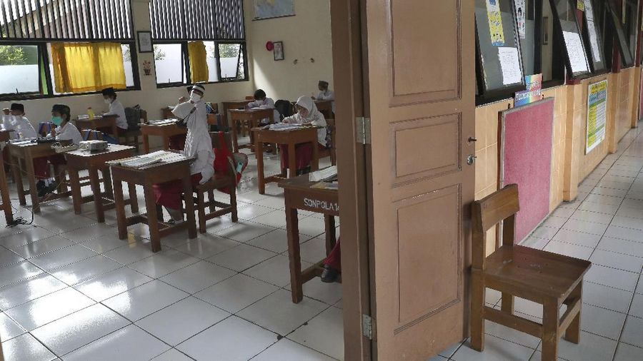 A student wearing a face mask sits spaced apart during a trial run of a class with COVID-19 protocols at an elementary school in Jakarta, Indonesia, Friday, June 4, 2021. The world's fourth-most populous country, with about 275 million people, has reported more coronavirus cases than any other Southeast Asian country. (AP Photo/Tatan Syuflana)