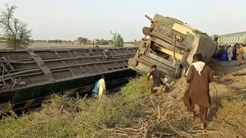 This image from a video, shows people gathering at the site of a train collision in Ghotki, Pakistan Monday, June 7, 2021. Two express trains collided in southern Pakistan early Monday, killing dozens of passengers, authorities said, as rescuers and villagers worked to pull injured people and more bodies from the wreckage. (AP Photo)
