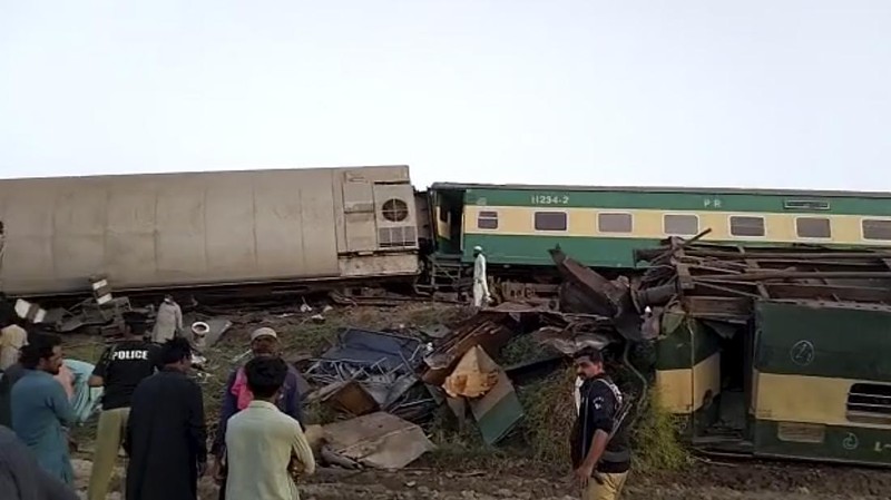 This image from a video, shows people gathering at the site of a train collision in Ghotki, Pakistan Monday, June 7, 2021. Two express trains collided in southern Pakistan early Monday, killing dozens of passengers, authorities said, as rescuers and villagers worked to pull injured people and more bodies from the wreckage. (AP Photo)