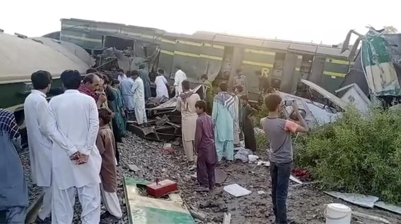 This image from a video, shows people gathering at the site of a train collision in Ghotki, Pakistan Monday, June 7, 2021. Two express trains collided in southern Pakistan early Monday, killing dozens of passengers, authorities said, as rescuers and villagers worked to pull injured people and more bodies from the wreckage. (AP Photo)
