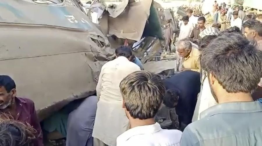 This image from a video, shows people gathering at the site of a train collision in Ghotki, Pakistan Monday, June 7, 2021. Two express trains collided in southern Pakistan early Monday, killing dozens of passengers, authorities said, as rescuers and villagers worked to pull injured people and more bodies from the wreckage. (AP Photo)