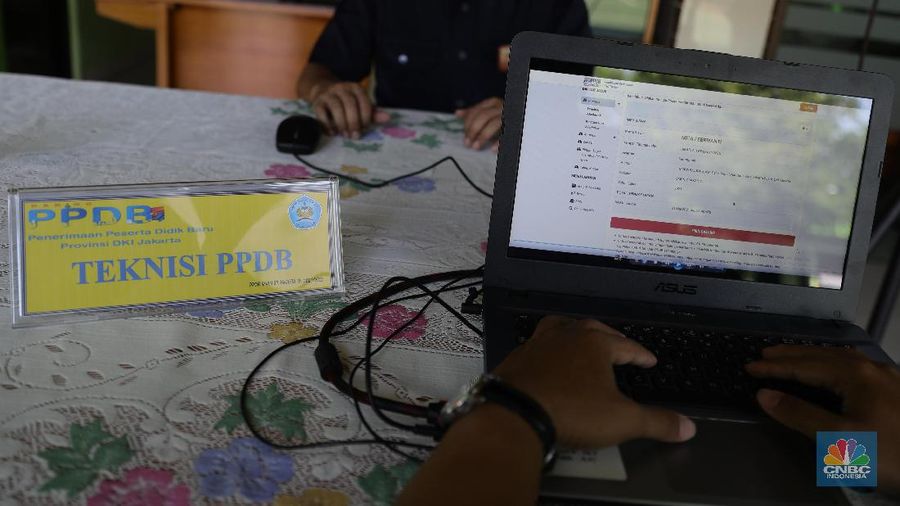 Orang tua murid mencari informasi pengajuan akun untuk mengikuti proses penerimaan Peserta Didik Baru (PPDB) Tahun Pelajaran 2021/2022 di Sekolah SMA Negeri 87 Jakarta, Senin (7/6). Proses penerimaan Peserta Didik Baru (PPDB) Tahun Pelajaran 2021/2022 di DKI Jakarta yang mulai dibuka sejak hari ini, Senin (7/6). Pada tahun ini, ada empat jalur pendaftaran yang dibuka meliputi jalur prestasi, afirmasi, zonasi, perpindahan tugas orang tua dan anak guru. Pada hari ini 7 Juni hingga 9 Juni 2021 PPDB dibuka khusus untuk jalur prestasi. Persyaratan PPDB Jakarta 2021 adalah ketentuan yang mewajibkan bahwa sekolah-sekolah negeri atau milik pemerintah yang ada di wilayah DKI Jakarta, hanya boleh menerima siswa yang terdaftar di Kartu Keluarga (KK) yang diterbitkan oleh Dinas Catatan Sipil dan Kependudukan Provinsi DKI Jakarta. Aturan ini PPDB DKI Jakarta 2021 juga telah diundangkan pada tanggal yang sama, dan dicatatkan dalam Berita Daerah Provinsi DKI Jakarta Tahun 2021 nomor 55005.
Pada pasal 1 ayat (11) Pergub No 32 Tahun 2021 tersebut meyebutkan, 