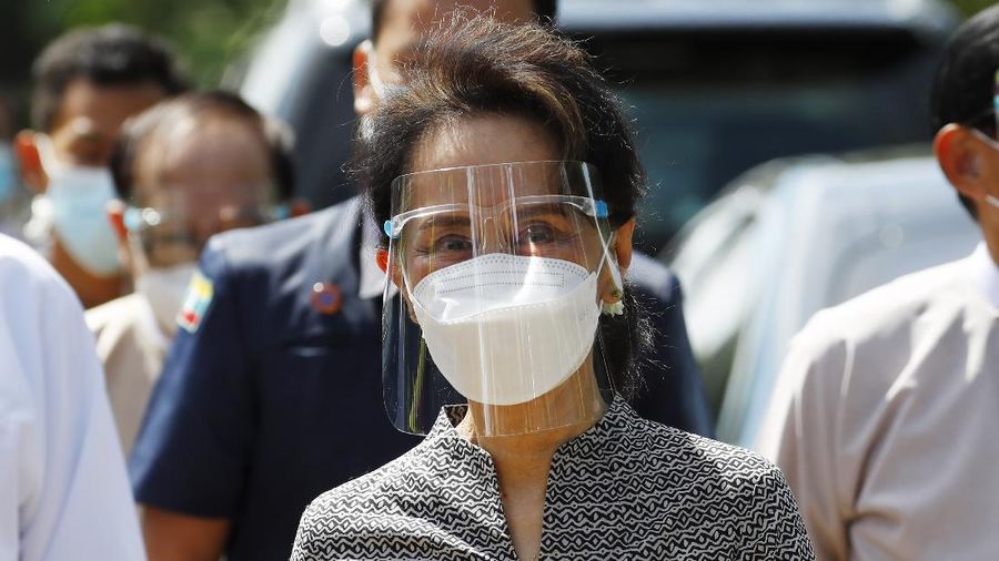 Myanmar leader Aung San Suu Kyi wearing a protective face mask and shield walks to greet supporters as she leaves after a demonstration of the voting for the upcoming Nov. 8 general elections, Tuesday, Oct. 20, 2020, in Naypyitaw, Myanmar. (AP Photo/Aung Shine Oo)