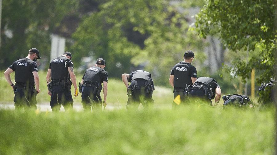 London Police investigate the scene of a car crash in London, Ontario on Monday, June 7, 2021. Police say multiple people have died after several pedestrians were struck by a car Sunday night. (Geoff Robins/The Canadian Press via AP)