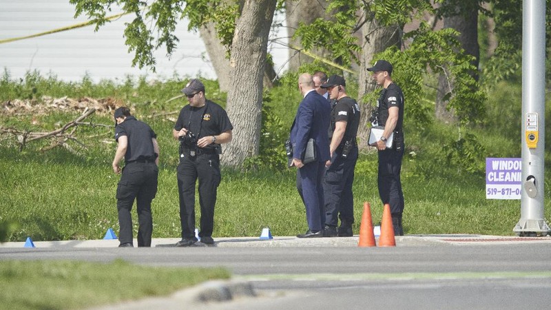 London Police investigate the scene of a car crash in London, Ontario on Monday, June 7, 2021. Police say multiple people have died after several pedestrians were struck by a car Sunday night. (Geoff Robins/The Canadian Press via AP)