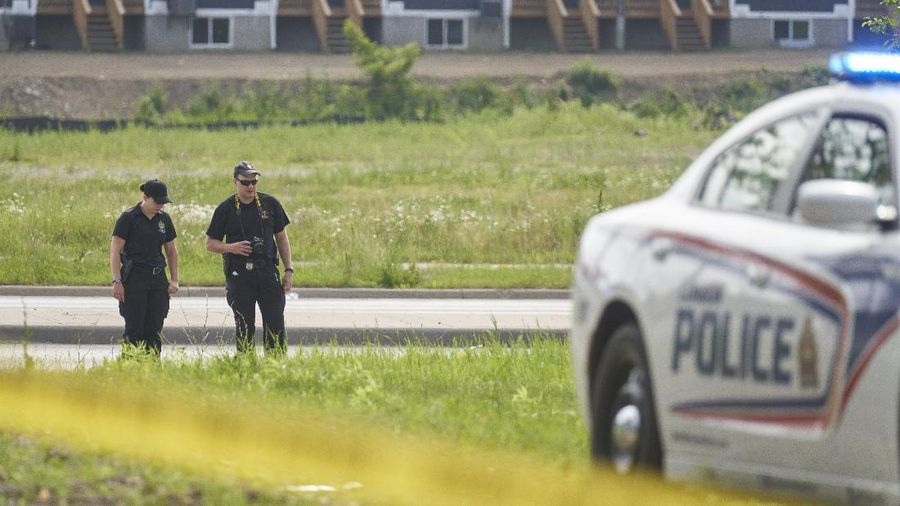 London Police investigate the scene of a car crash in London, Ontario on Monday, June 7, 2021. Police say multiple people have died after several pedestrians were struck by a car Sunday night. (Geoff Robins/The Canadian Press via AP)