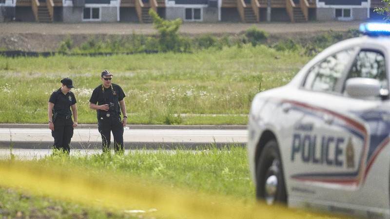 London Police investigate the scene of a car crash in London, Ontario on Monday, June 7, 2021. Police say multiple people have died after several pedestrians were struck by a car Sunday night. (Geoff Robins/The Canadian Press via AP)