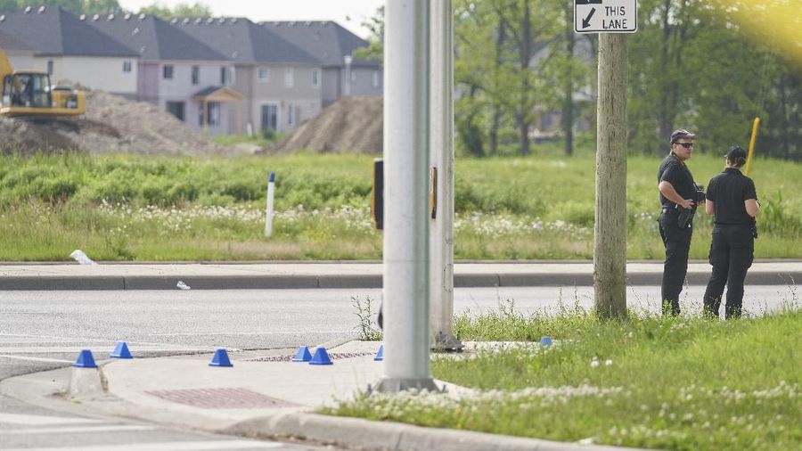 London Police investigate the scene of a car crash in London, Ontario on Monday, June 7, 2021. Police say multiple people have died after several pedestrians were struck by a car Sunday night. (Geoff Robins/The Canadian Press via AP)