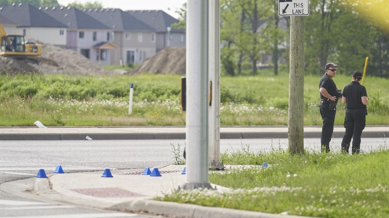 London Police investigate the scene of a car crash in London, Ontario on Monday, June 7, 2021. Police say multiple people have died after several pedestrians were struck by a car Sunday night. (Geoff Robins/The Canadian Press via AP)