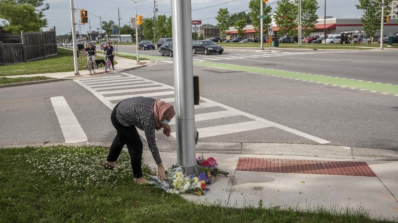 London Police investigate the scene of a car crash in London, Ontario on Monday, June 7, 2021. Police say multiple people have died after several pedestrians were struck by a car Sunday night. (Geoff Robins/The Canadian Press via AP)