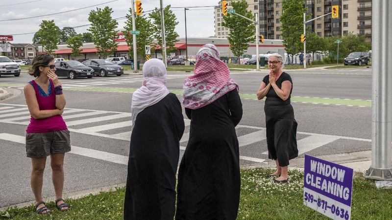 London Police investigate the scene of a car crash in London, Ontario on Monday, June 7, 2021. Police say multiple people have died after several pedestrians were struck by a car Sunday night. (Geoff Robins/The Canadian Press via AP)