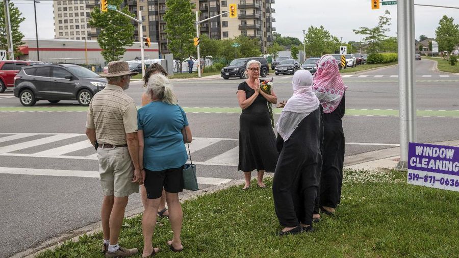 London Police investigate the scene of a car crash in London, Ontario on Monday, June 7, 2021. Police say multiple people have died after several pedestrians were struck by a car Sunday night. (Geoff Robins/The Canadian Press via AP)