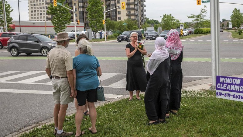 London Police investigate the scene of a car crash in London, Ontario on Monday, June 7, 2021. Police say multiple people have died after several pedestrians were struck by a car Sunday night. (Geoff Robins/The Canadian Press via AP)