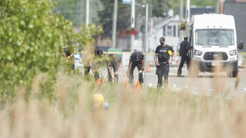London Police investigate the scene of a car crash in London, Ontario on Monday, June 7, 2021. Police say multiple people have died after several pedestrians were struck by a car Sunday night. (Geoff Robins/The Canadian Press via AP)