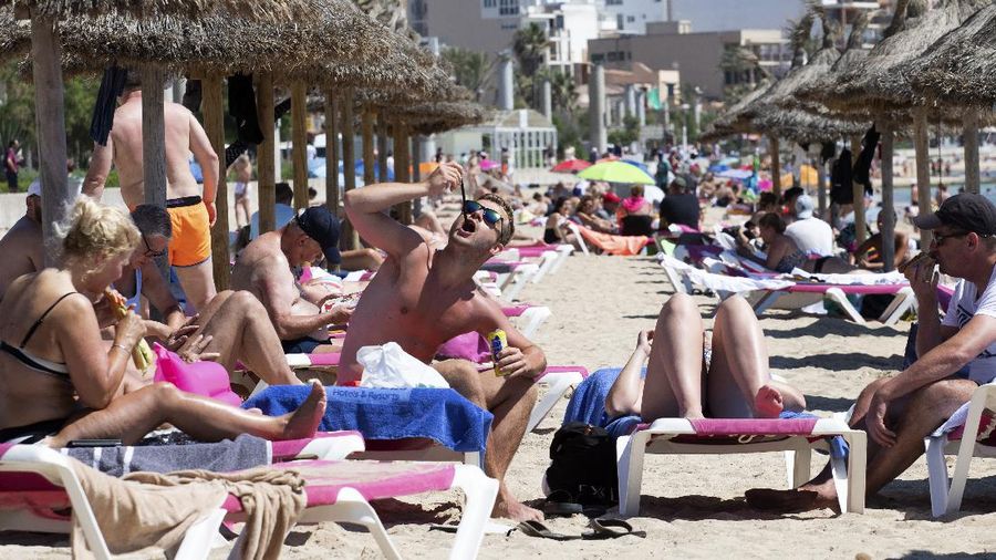 Tourists sunbathe on the beach at the Spanish Balearic Island of Mallorca, Spain, Monday, June 7, 2021. Spain is jumpstarting its summer tourism season by welcoming vaccinated visitors from most countries as well as European visitors who can prove they are not infected with coronavirus. It also reopened its ports to cruise ship stops on Monday. (AP Photo/Francisco Ubilla)
