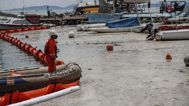 People ride a canoe by the Caddebostan shore, on the Asian side of Istanbul, Tuesday, June 8, 2021, surrounded by a huge mass of marine mucilage, a thick, slimy substance made up of compounds released by marine organisms, in Turkey's Marmara Sea. Turkey’s president has promised to rescue the Marmara Sea from an outbreak of “sea snot” that is alarming marine biologists and environmentalists. A huge mass of marine mucilage has bloomed in Turkey’s Marmara and the adjoining Black and Aegean Seas. Turkish President Recep Tayyip Erdogan said untreated waste dumped into the Marmara Sea and climate change had caused the bloom of the thick, slimy substance made up of compounds released by marine organisms, Istanbul, Turkey’s largest city, borders the sea. (AP Photo/Kemal Aslan)