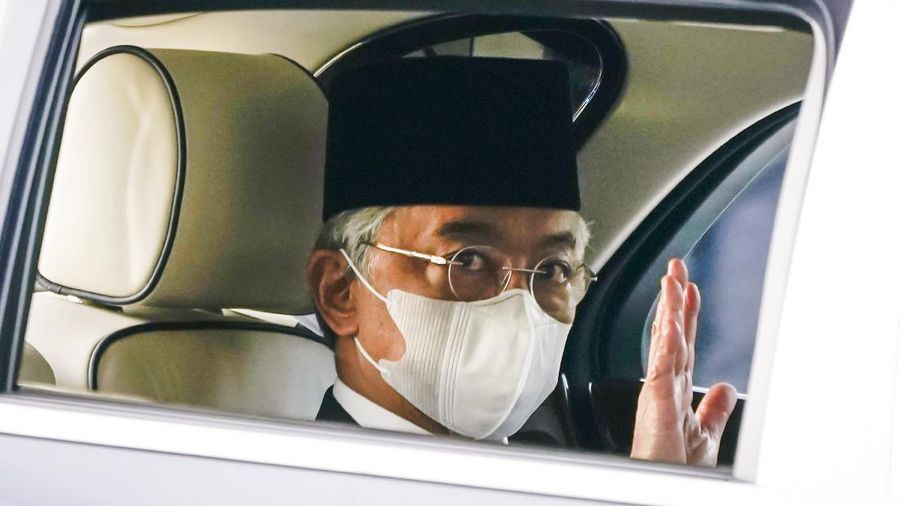 Malaysia's King Sultan Abdullah Sultan Ahmad Shah waves as he leaves National Palace in Kuala Lumpur, Malaysia, Sunday, Oct. 25, 2020. National Palace statement says Malay rulers has decided not to accede to Prime Minister Muhyiddin Yassin's request to declare a state of emergency. (AP Photo/Vincent Thian)