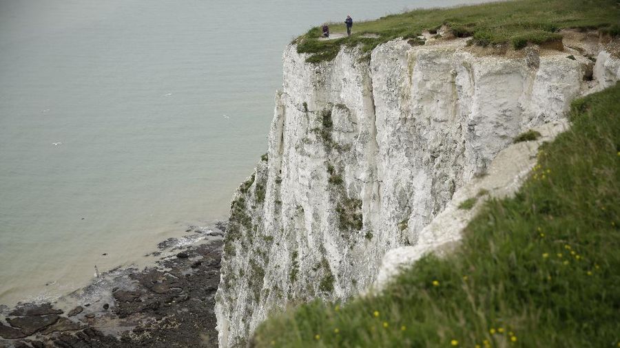 Tourists visit the White Cliffs of Dover, south east England, Thursday, June 9, 2016. On a clear day, the coast of France is visible from Dovers famous white cliffs, and they provided a vital vantage point for the early spotting of German bombers heading toward London during World War II. The concern now is not enemy attack, although an armed Russian submarine was recently intercepted in the Channel. Instead, it is Europeans who arrive legally under EU rules guaranteeing the free movement of people. (AP Photo/Matt Dunham)