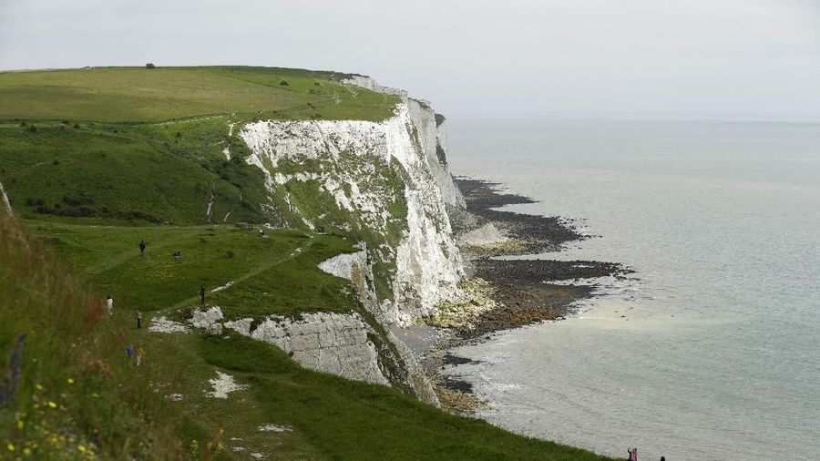 Tourists visit the White Cliffs of Dover, south east England, Thursday, June 9, 2016. On a clear day, the coast of France is visible from Dovers famous white cliffs, and they provided a vital vantage point for the early spotting of German bombers heading toward London during World War II. The concern now is not enemy attack, although an armed Russian submarine was recently intercepted in the Channel. Instead, it is Europeans who arrive legally under EU rules guaranteeing the free movement of people. (AP Photo/Matt Dunham)